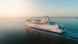 white and blue Brittany Ferries ferry sailing at the bay