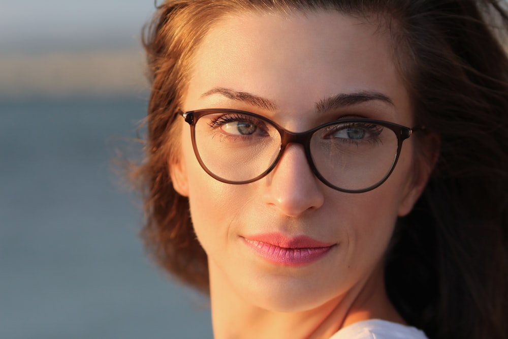 woman wearing eyeglasses and pink lipstick