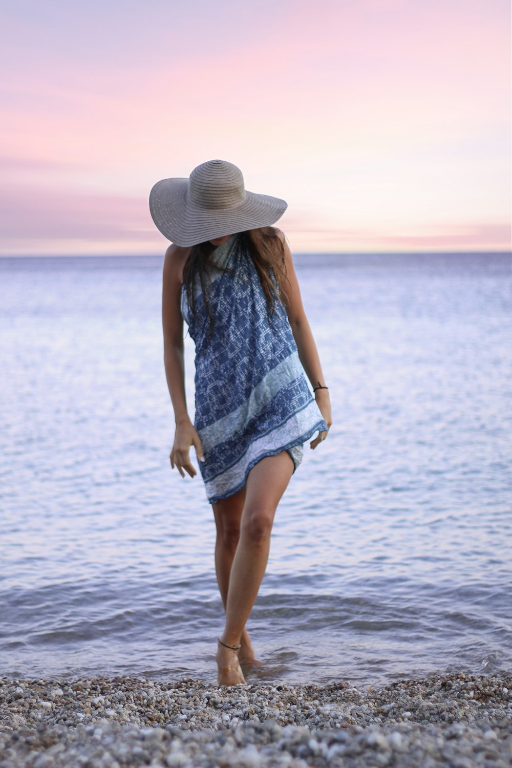woman in blue and white dress wearing sunny hat