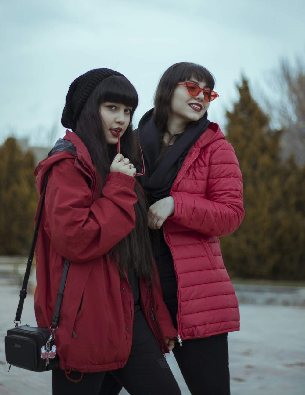 two women wearing coats