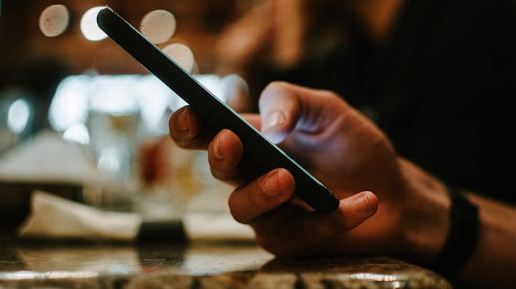 A hand holding a smartphone