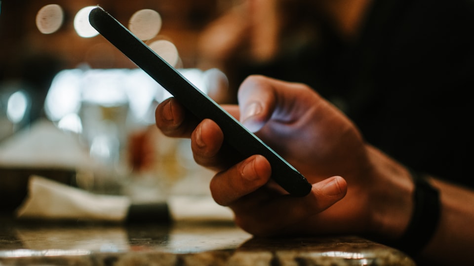 A hand holding a smartphone