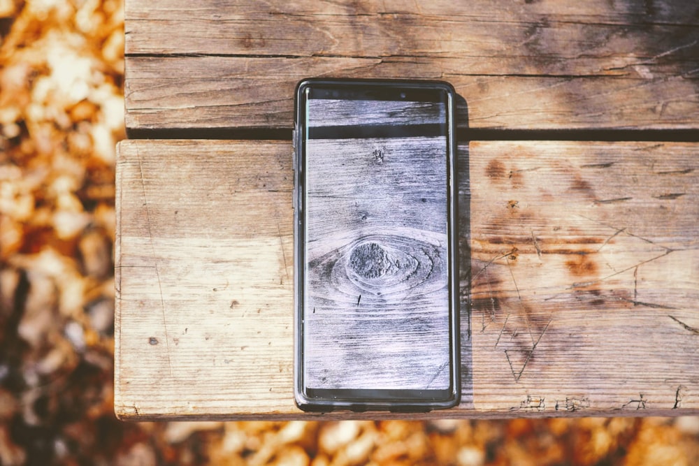 turned-on smartphone on picnic table