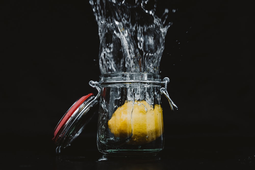 klares Glasgefäß mit Zitrone und Wasser