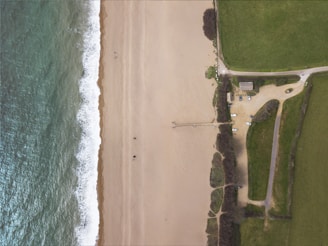 Aerial shot showing the parking lot just steps away from a sandy beach.