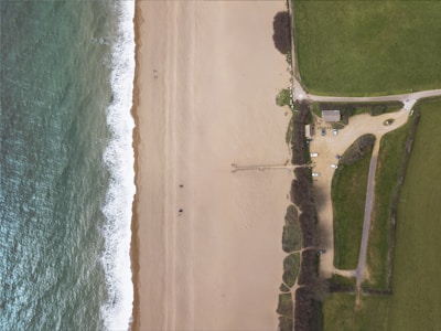 Aerial shot showing the parking lot just steps away from a sandy beach.