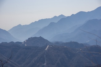 The majestic Great Wall of China winding over misty hills at dawn.