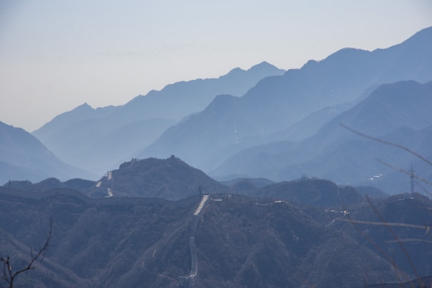 The majestic Great Wall of China winding over misty hills at dawn.