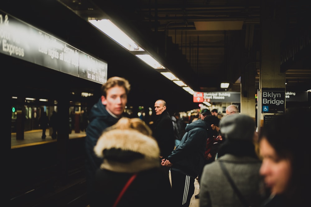 selective focus photography of crowd on train station