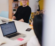 smiling man beside writing person