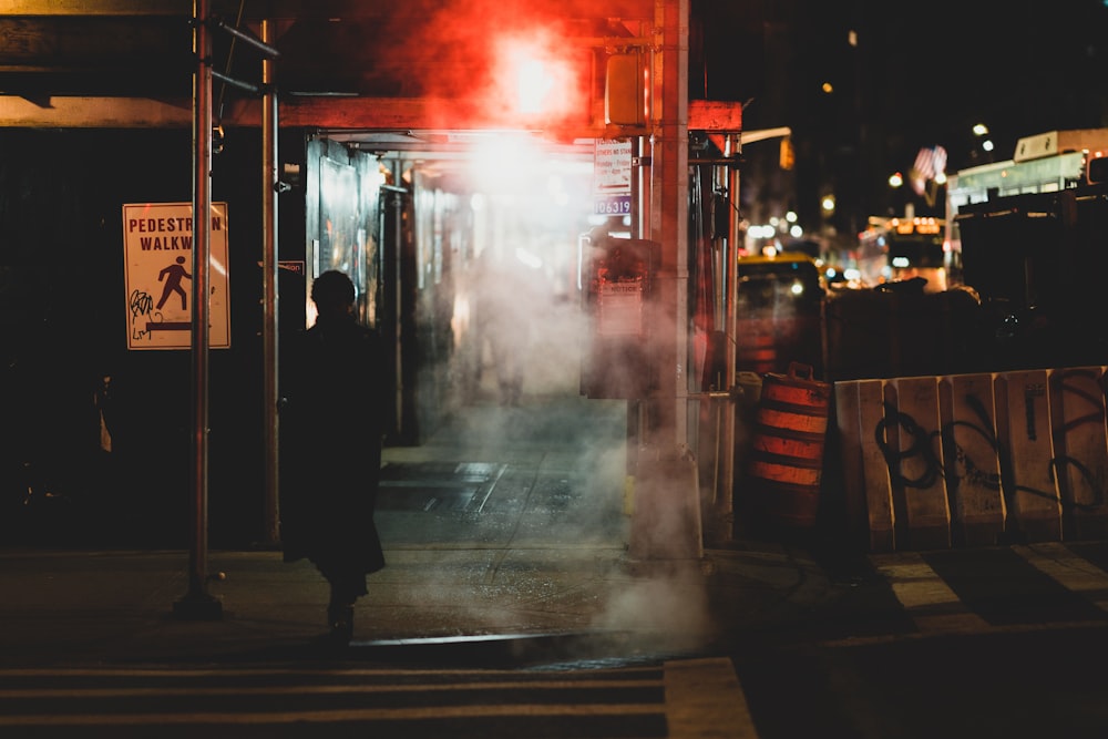 person walking near road during nighttime