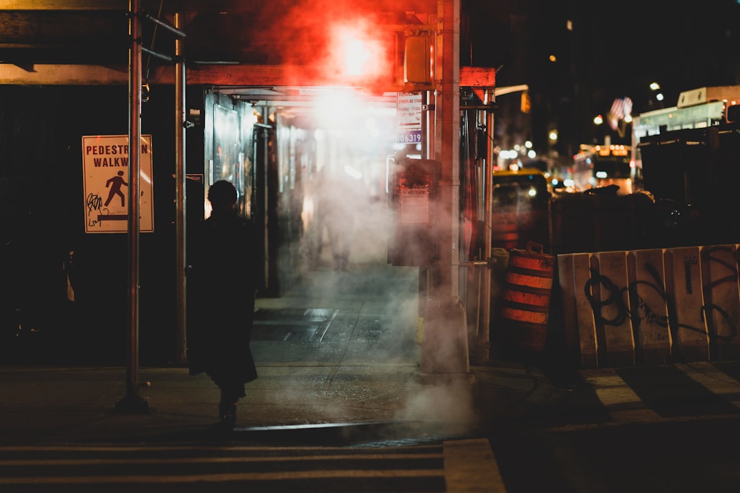 person walking near road during nighttime