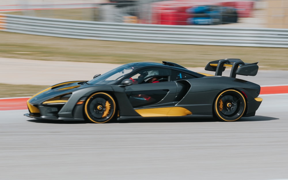 panning photography of black and yellow coupe