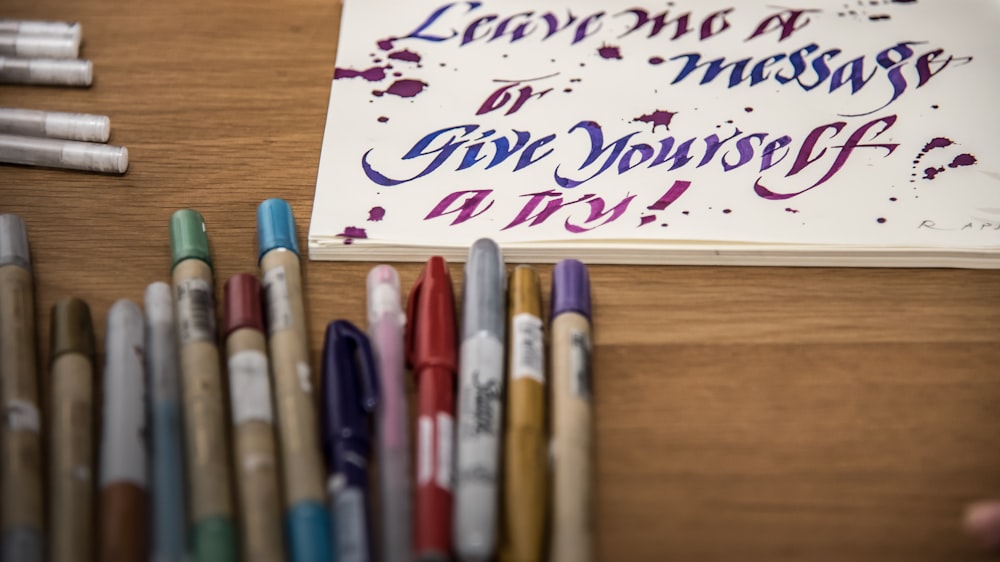 assorted color pens on table