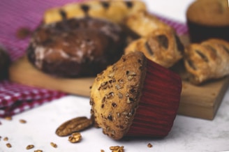 Close-up of a rustic wooden board displaying an assortment of freshly baked breads and pastries from mom's bakery.