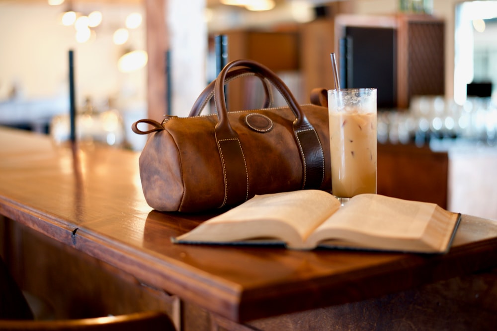 black beside drinking glass and book on table