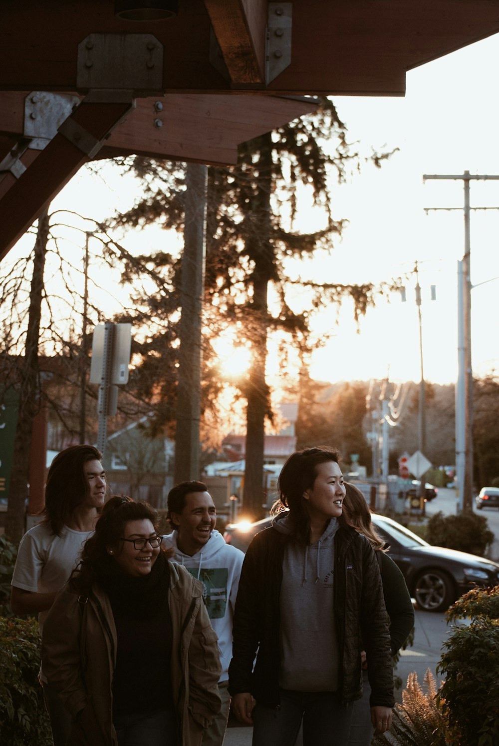 people walking at the sidewalk during sunset