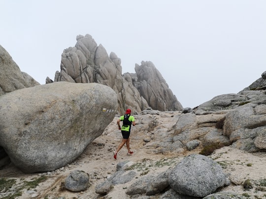 person running between rock formations in Manzanares el Real Spain