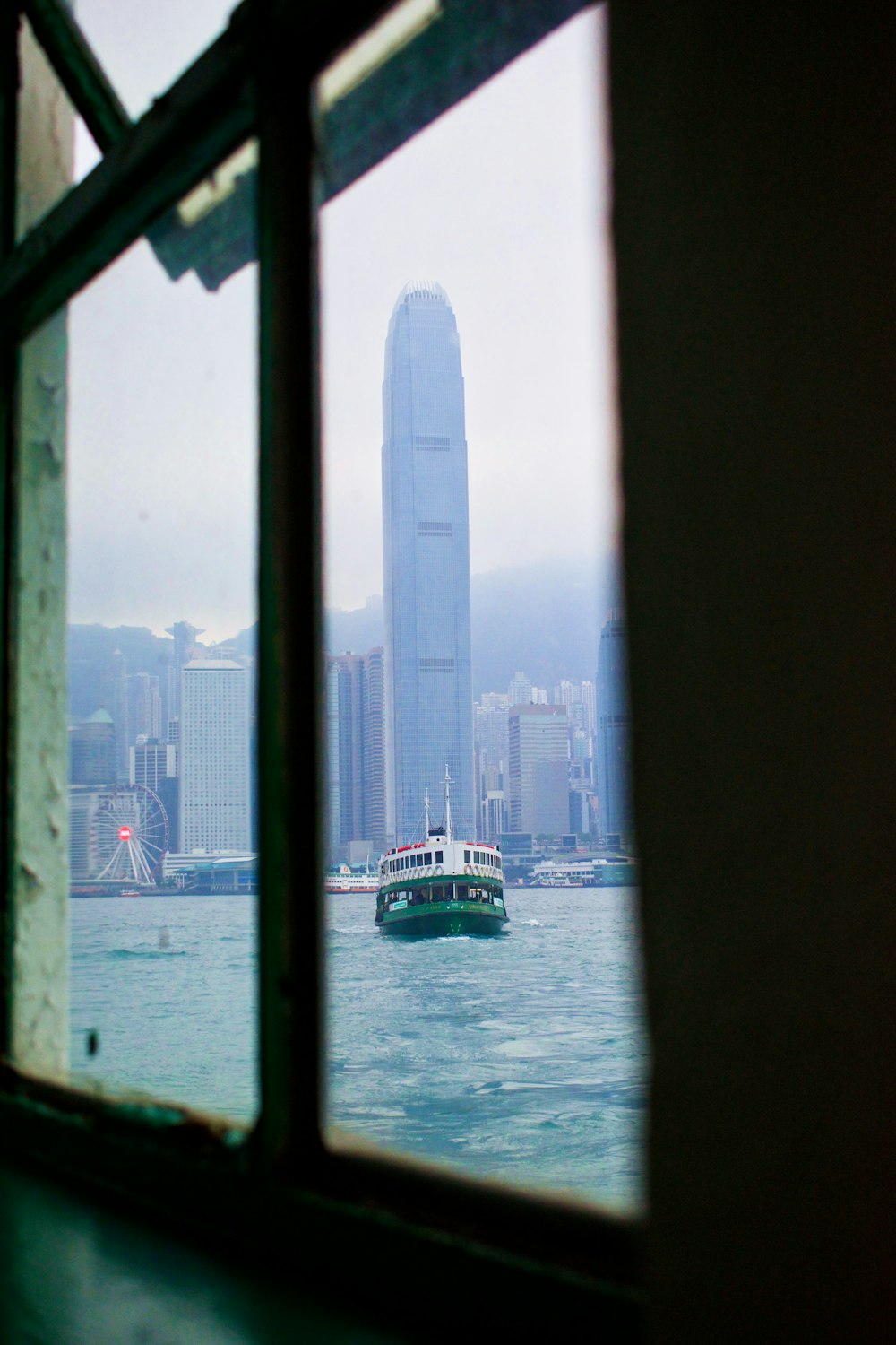 white and green boat on body of water