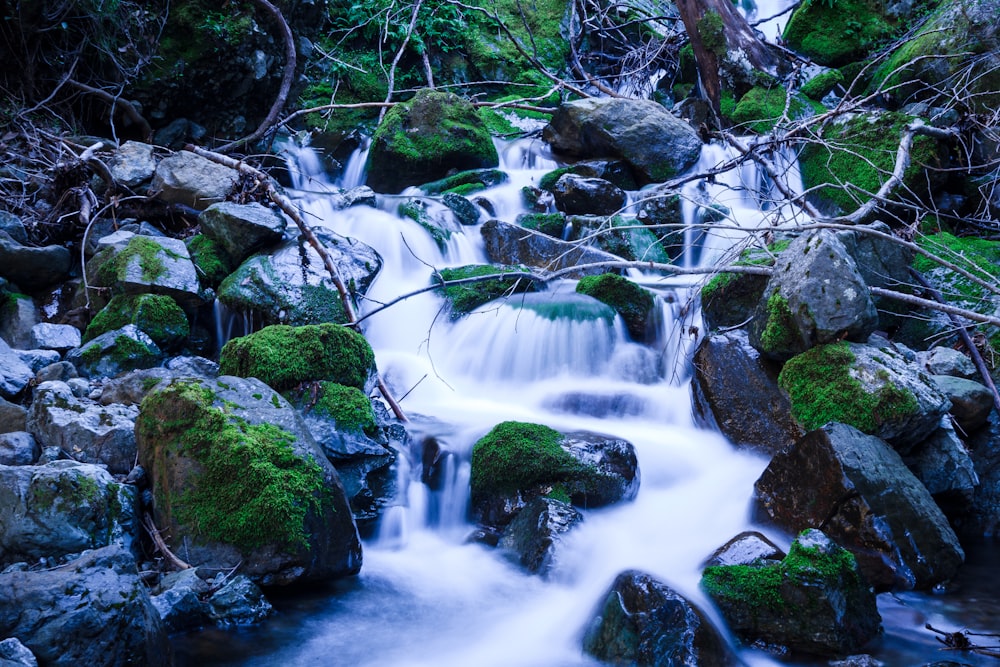 time-lapse photography of water flowing on rocks