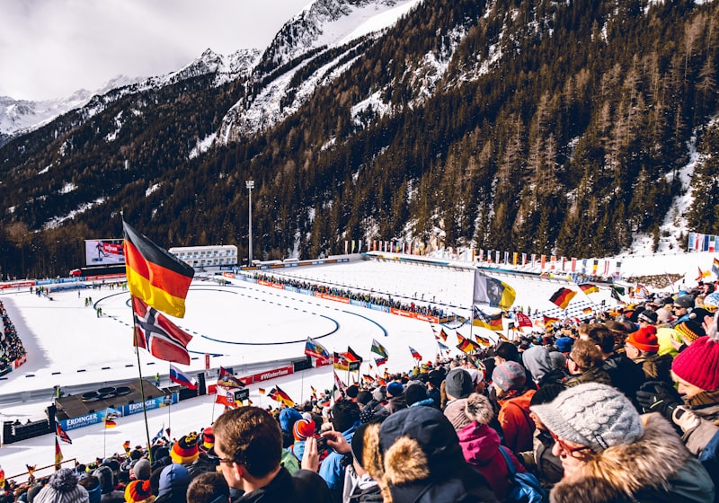 biathlon competition, ski shooting range, cross-country skiing, winter Olympics athletes, relay race