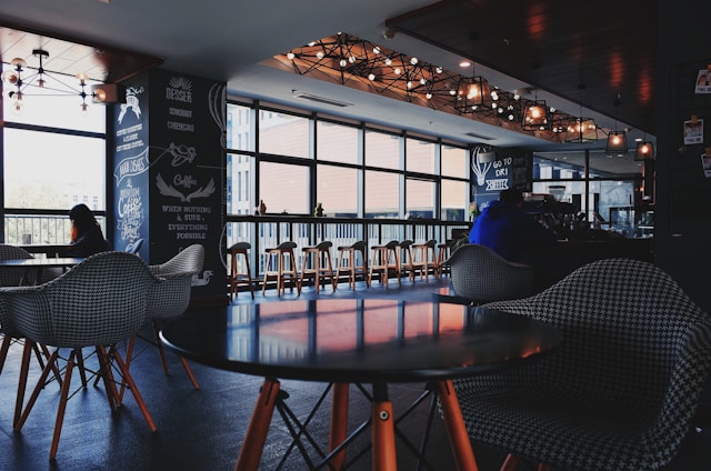 A modern café interior with warm lighting and curved design elements reflecting Alsanad Alamthal's style.