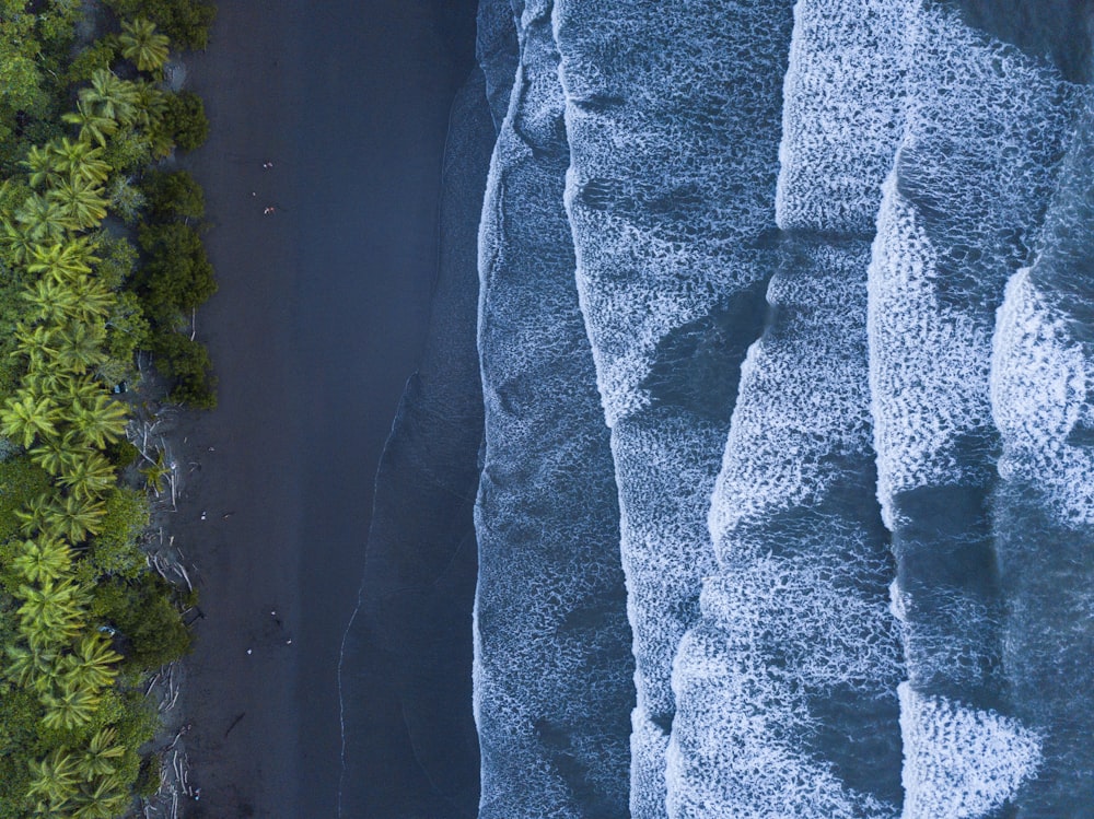 an aerial view of a road between two mountains