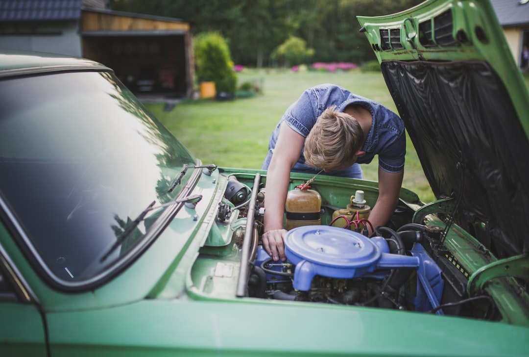 man checking vehicle engine