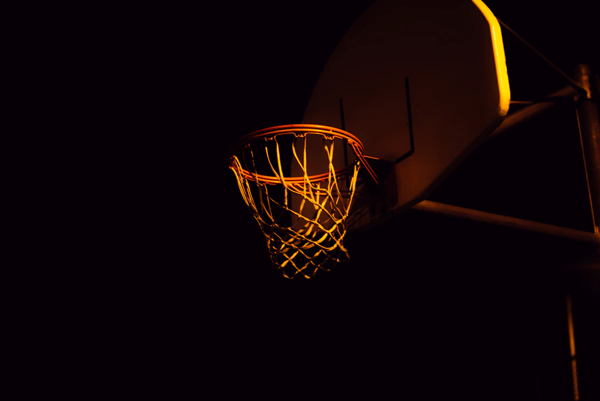 A basketball hoop lit gold at night