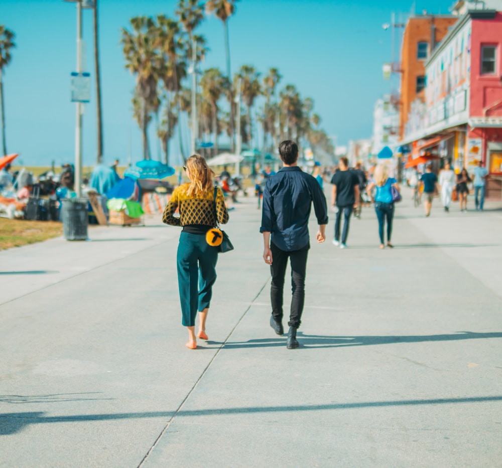man and woman walking on street