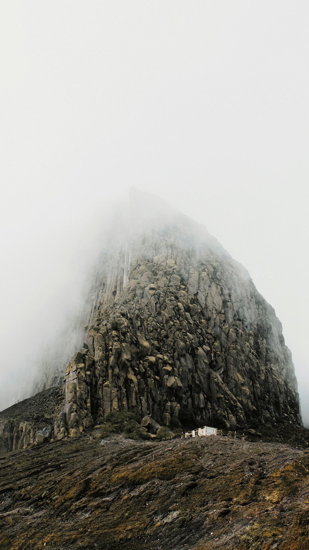 gray rock formation under white skies