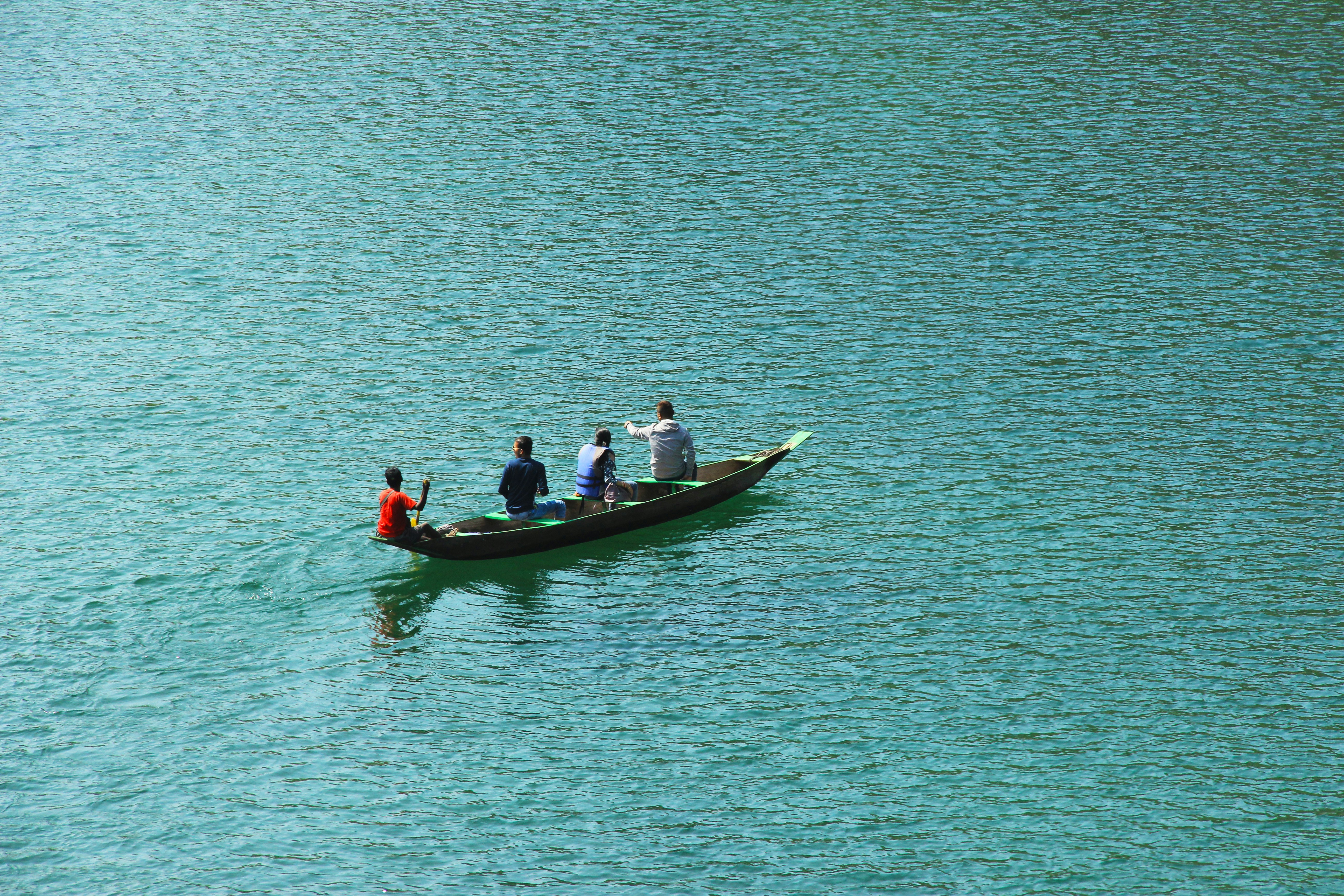 four person boating on body of water