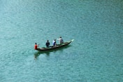 four person boating on body of water