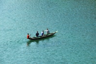 four person boating on body of water
