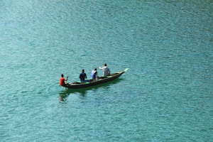 four person boating on body of water
