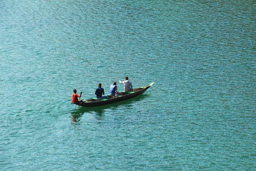 four person boating on body of water