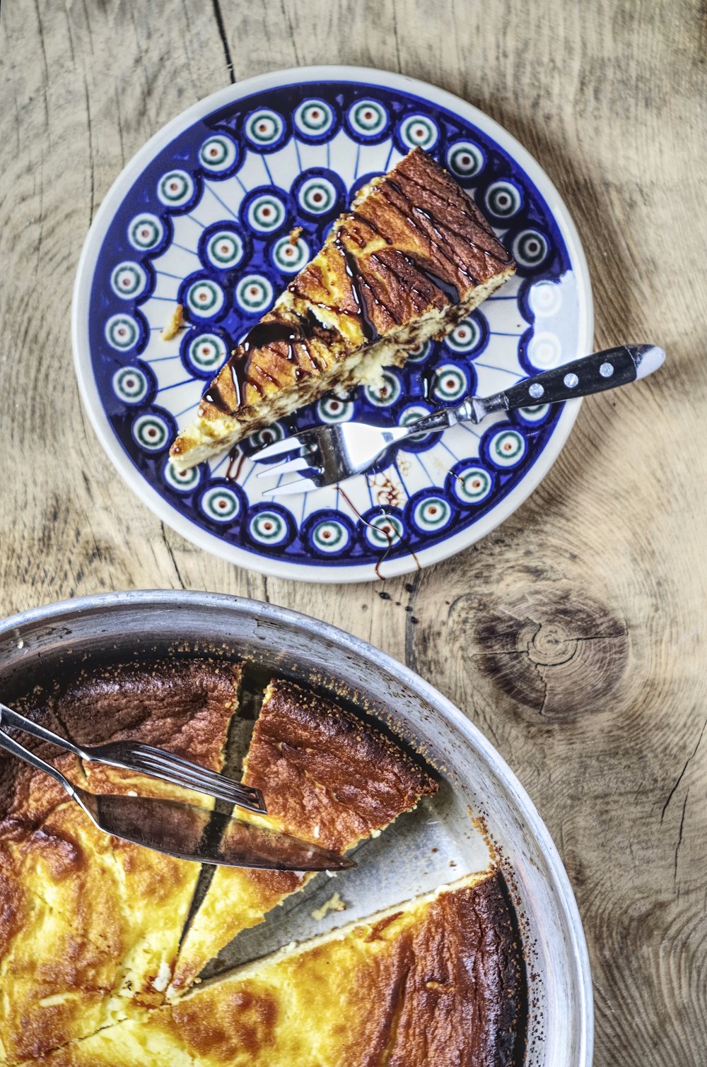 sliced pie on plate beside ford on table