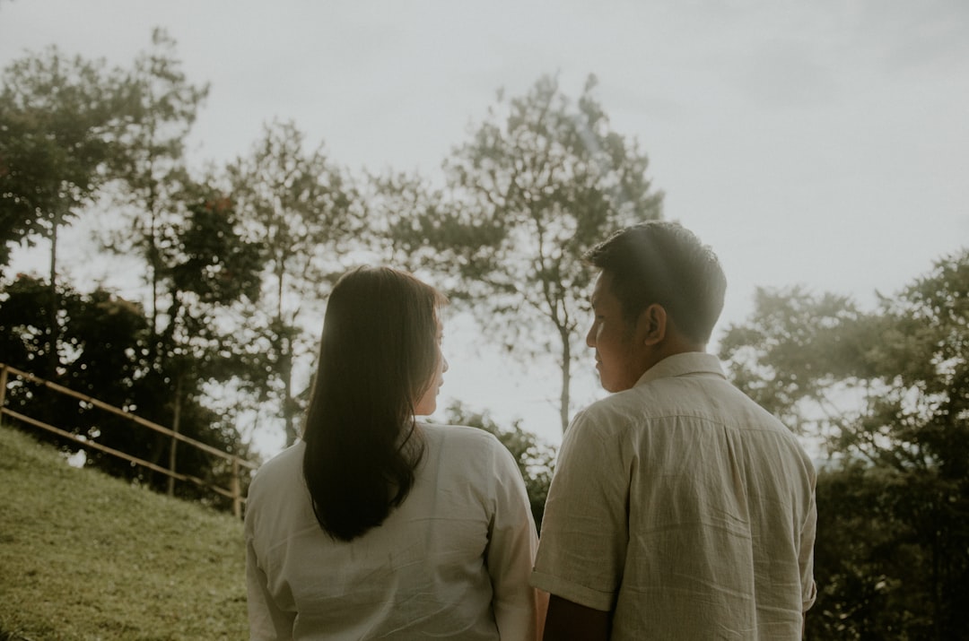 couple near green field during daytime