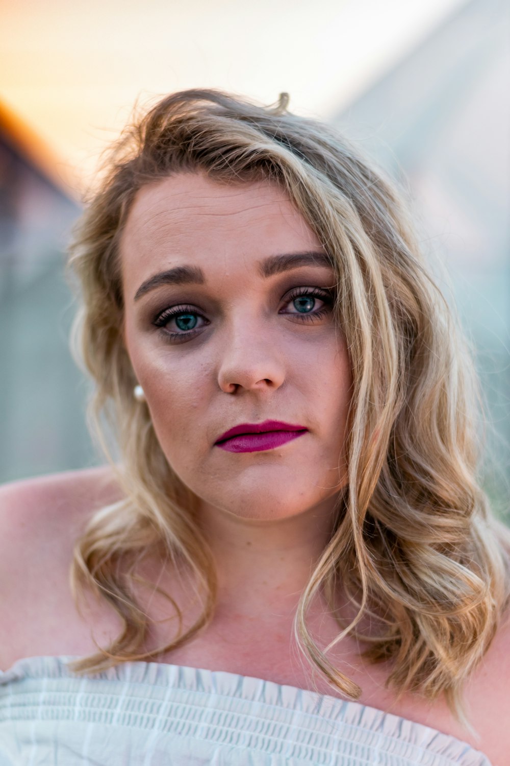 woman wearing white top and pink lipstick