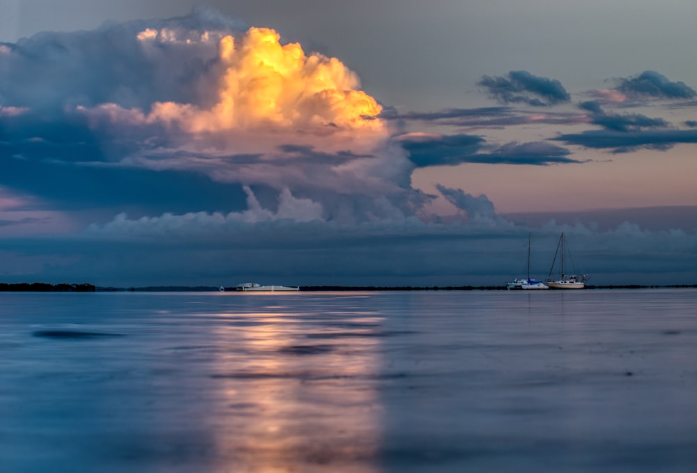 boat on body of water during sunrise