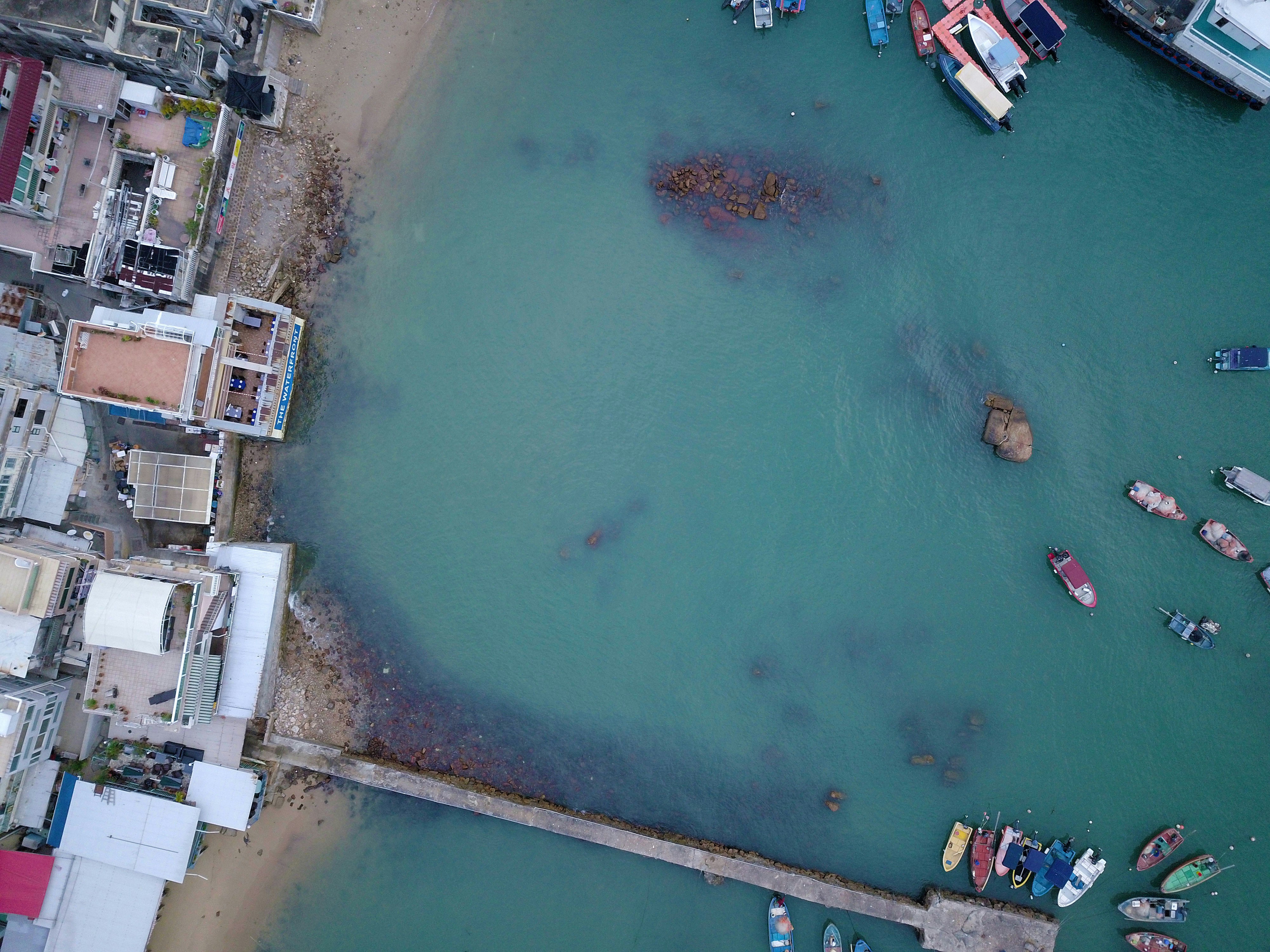 top-view photography of boat in body of water during daytime