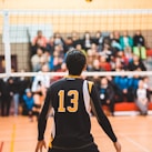 man wearing black 13 volleyball jersey