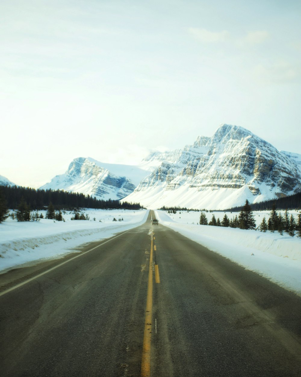 road leading towards snowy mountain