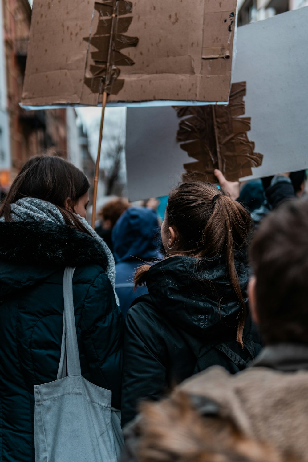 two women holding banners