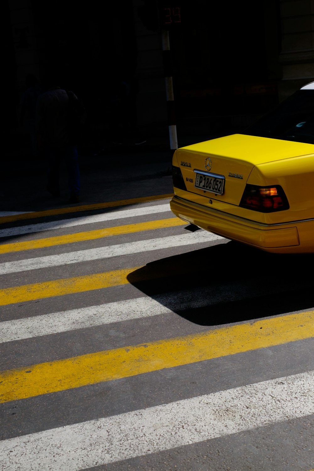 yellow vehicle passing on pedestrian lane