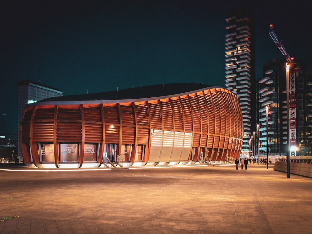 brown wooden framed building near building at nighttime