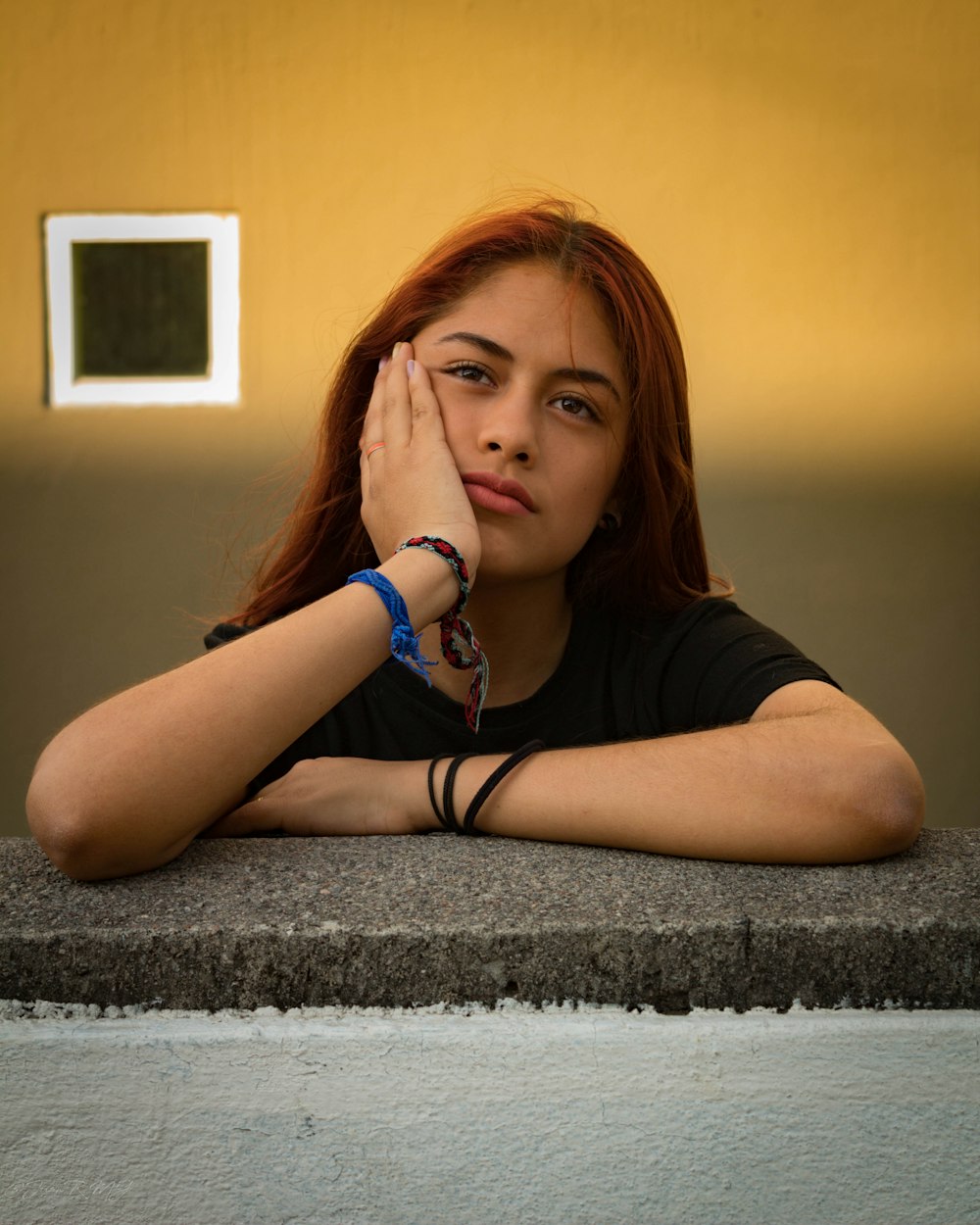 woman standing and leaning on concrete pavement