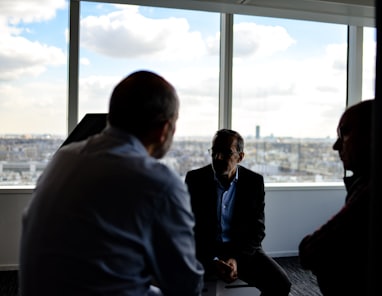 people sitting near window having conversations