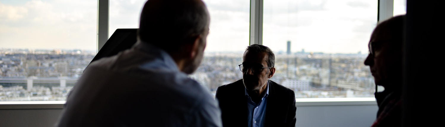 people sitting near window having conversations