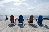 Aluminum Adirondack chair painted soft blue, set on a sunlit porch.